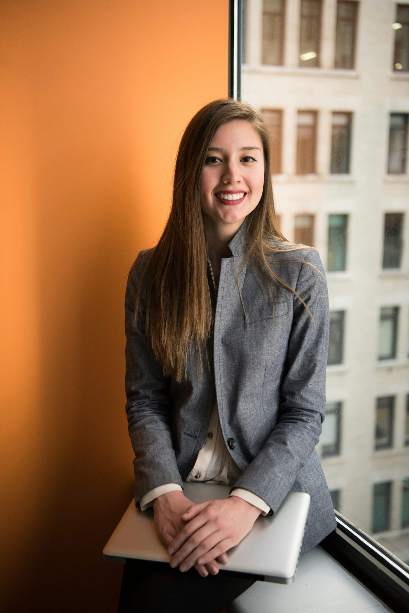 Professional smiling in an office after a booked client appointment